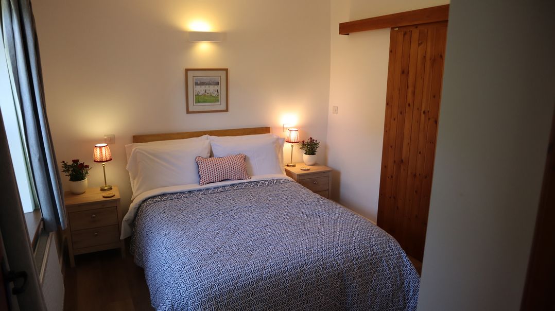 A bedroom with a bed and bedside tables at Castle Rag in Parkend