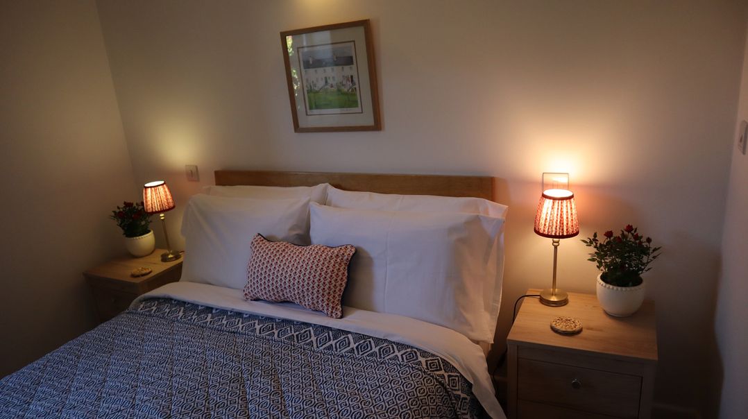 A bedroom with a bed and lamps at Castle Rag in Parkend