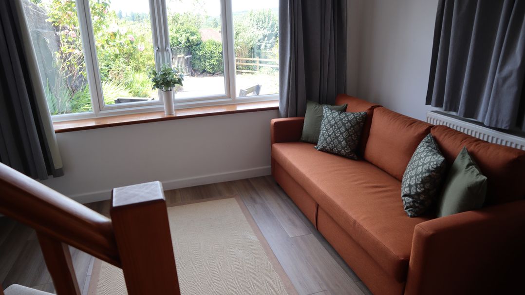 A living room with a sofa and a view outside at Horse Gin in Parkend