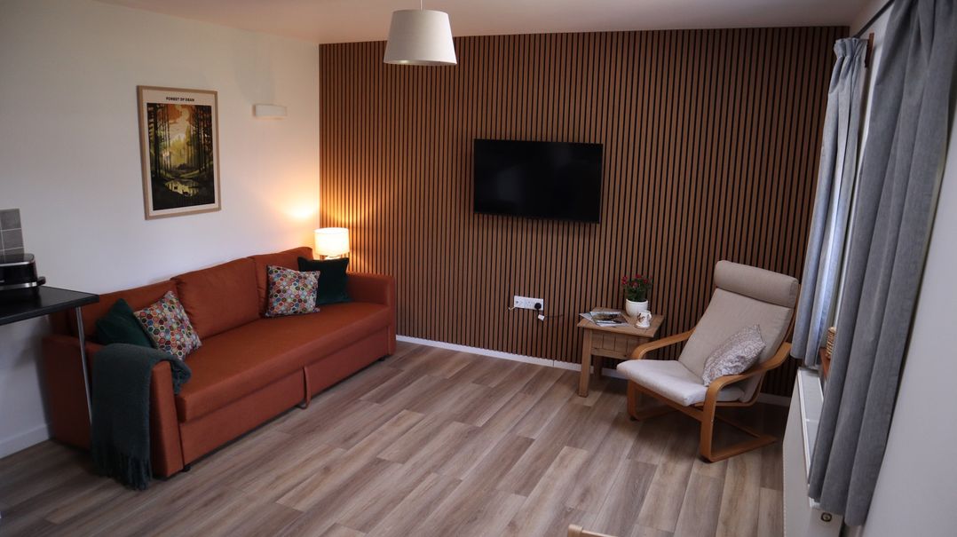A living room with a sofa and television at Castle Rag in Parkend