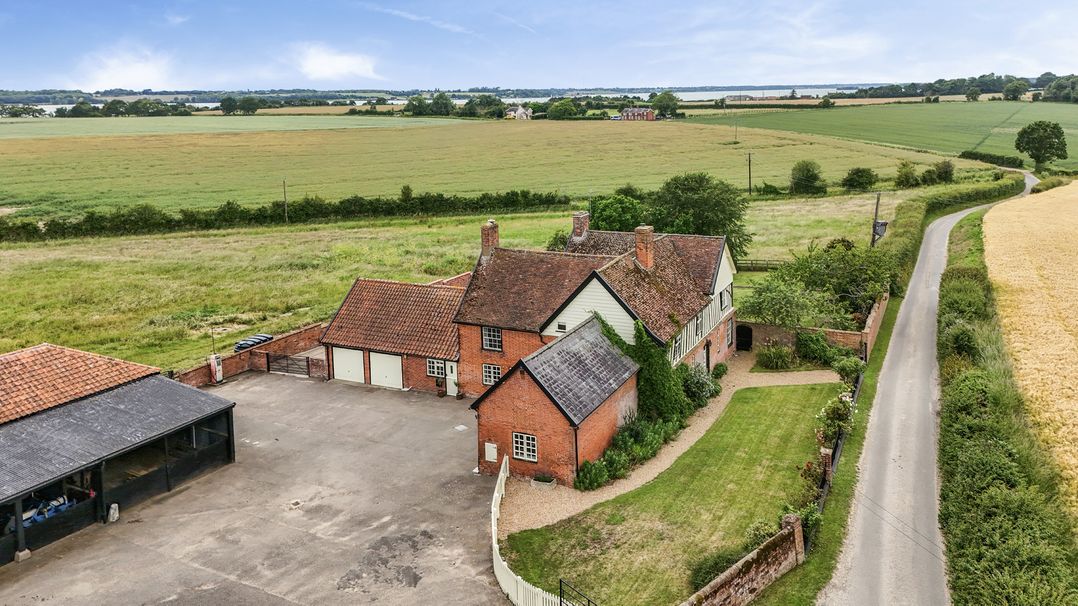 An exterior view of a house with a garage and garden at Knights Farm in Harkstead