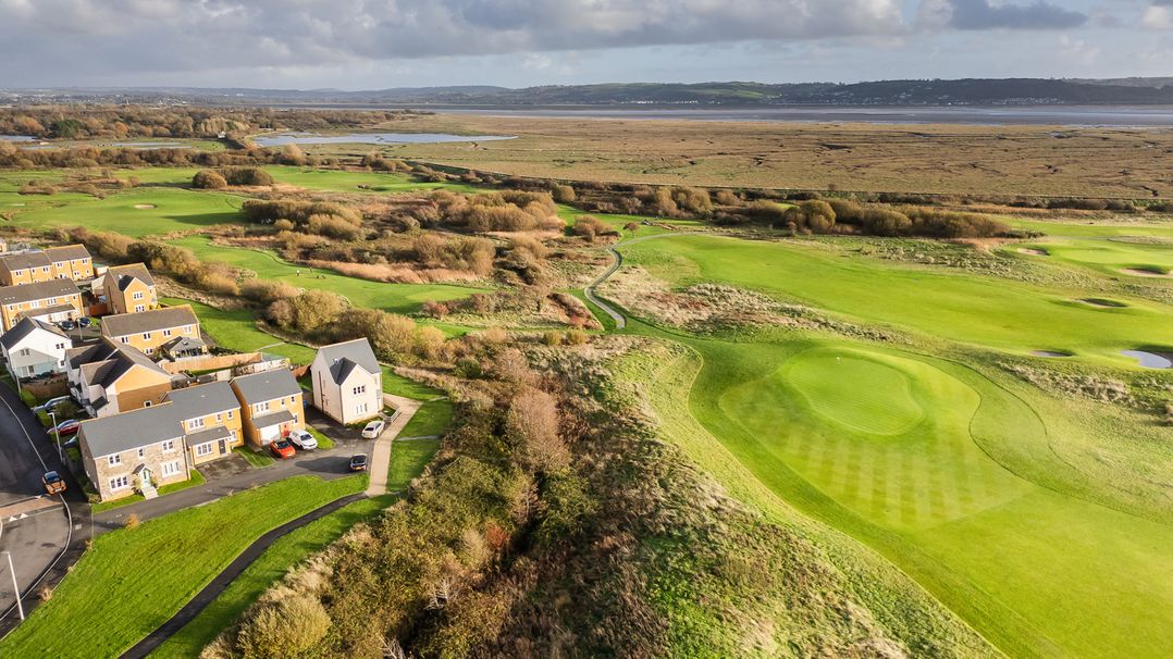 An aerial view of a golf course and residential area at 69 Ffordd Y Meillion Llanelli