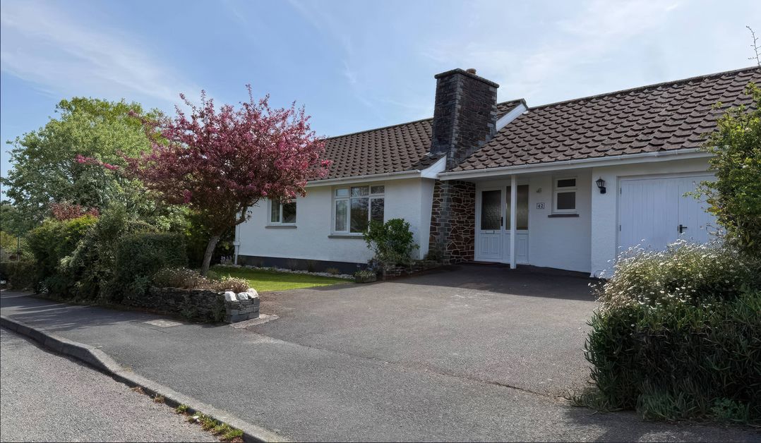 A house with a driveway and tree at 42 Little Trelyn in Rock