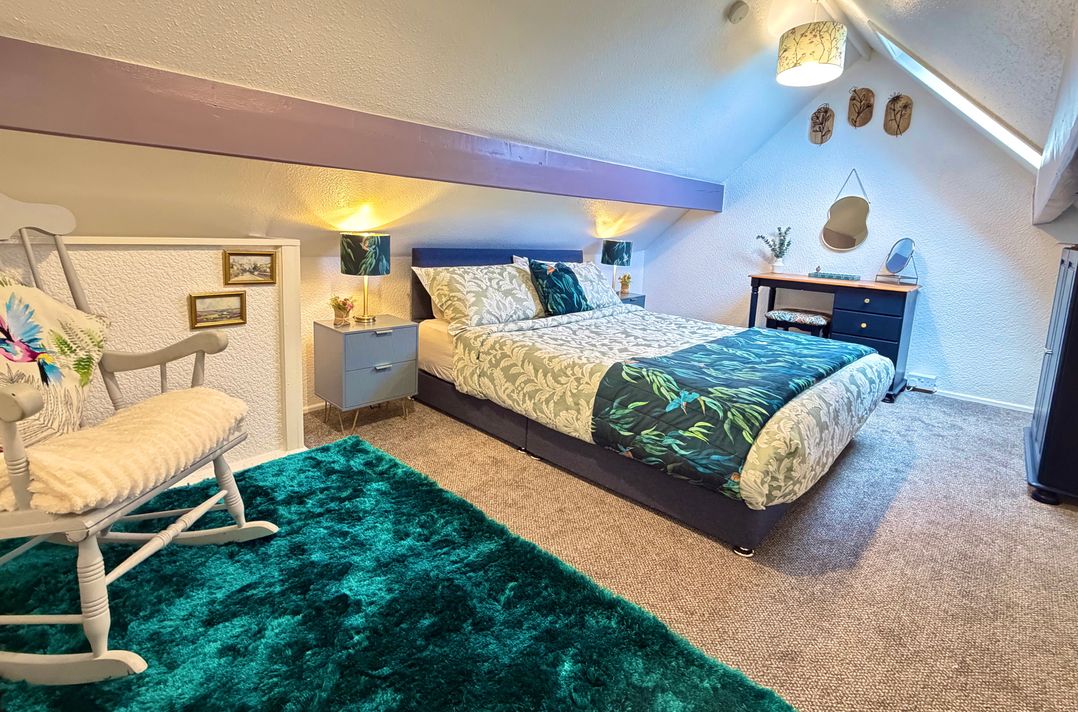 A bedroom with a bed and desk at Wayside Farm Cart Cottage Cloughton near Burniston