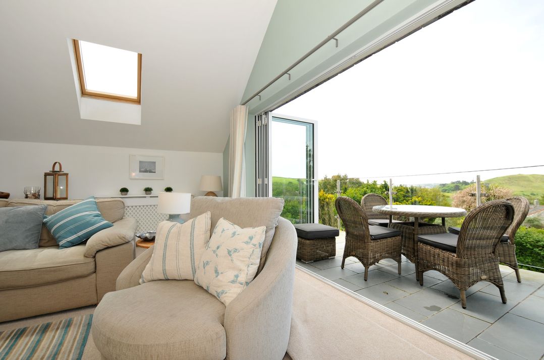 A living room with a sofa and armchair at Farlands in Daymer Bay