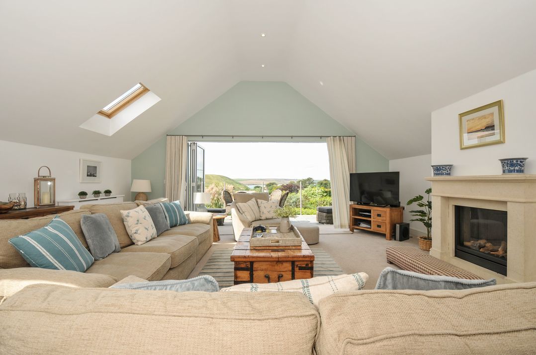 A living room with a sofa and coffee table at Farlands in Daymer Bay