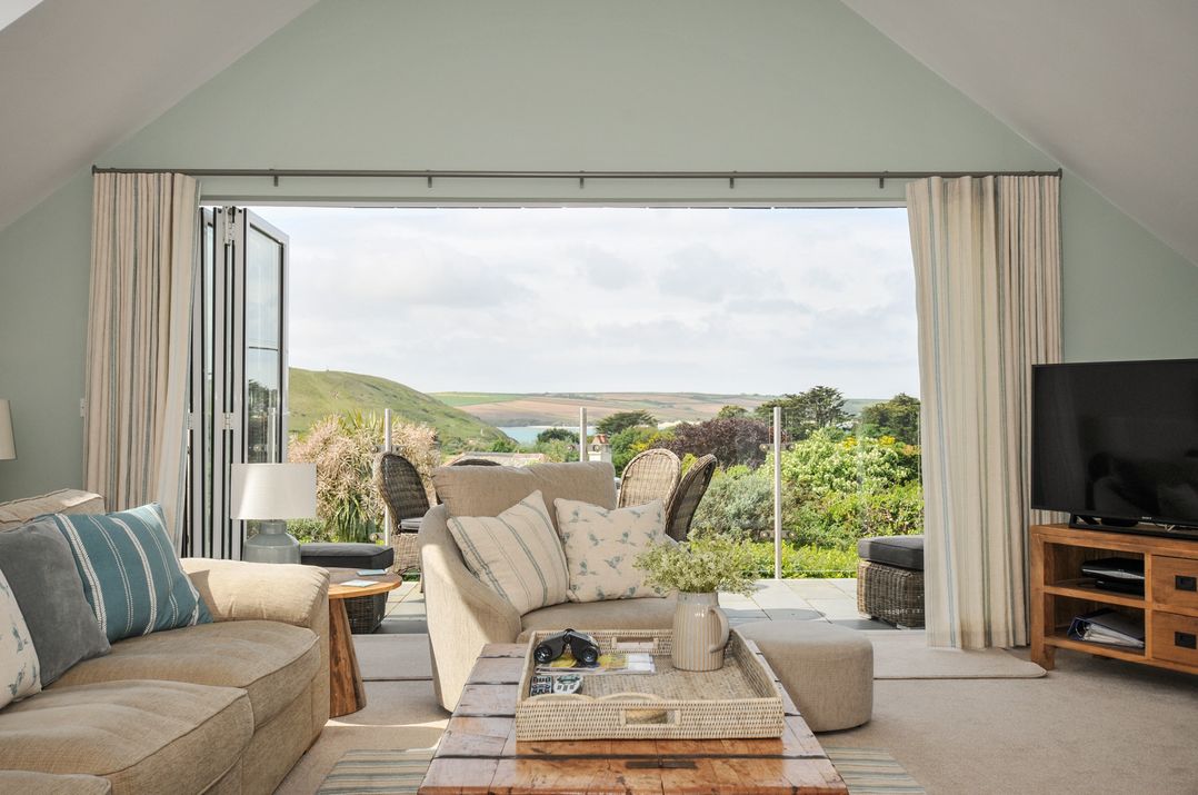 A living room with a sofa and coffee table at Farlands, Daymer Bay