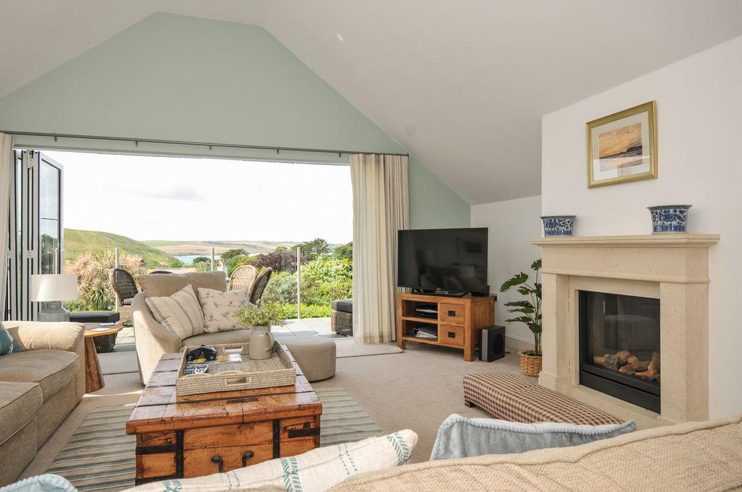 A living room with a television and a coffee table at Farlands Daymer Bay