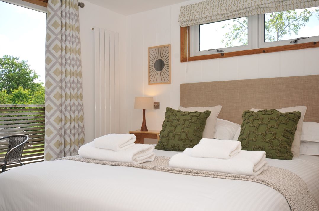 A bedroom with a bed and pillows at 12 Meadow Retreat in Dobwalls