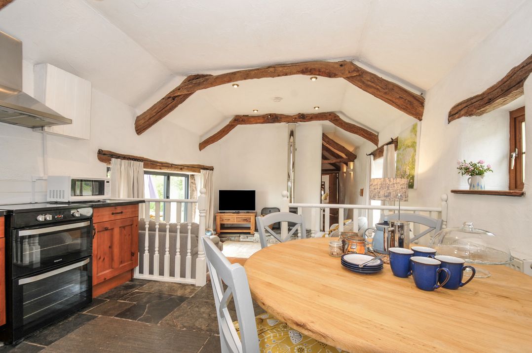 A kitchen with a dining table and television at Skiber Long Bray Shop near Launceston