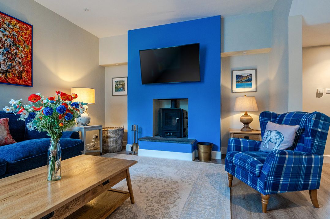 A living room with a sofa and television at Home Farmhouse at the Graythwaite Estate near Hawkshead