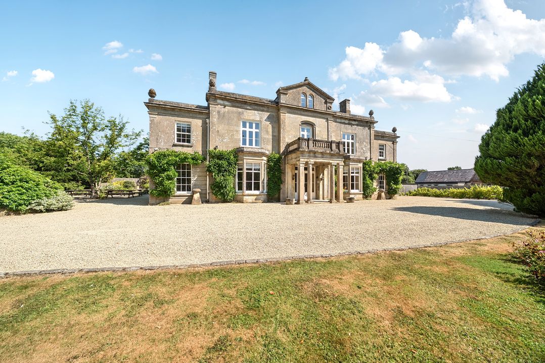 A house with windows and an entrance at Milton Manor in Milton On Stour