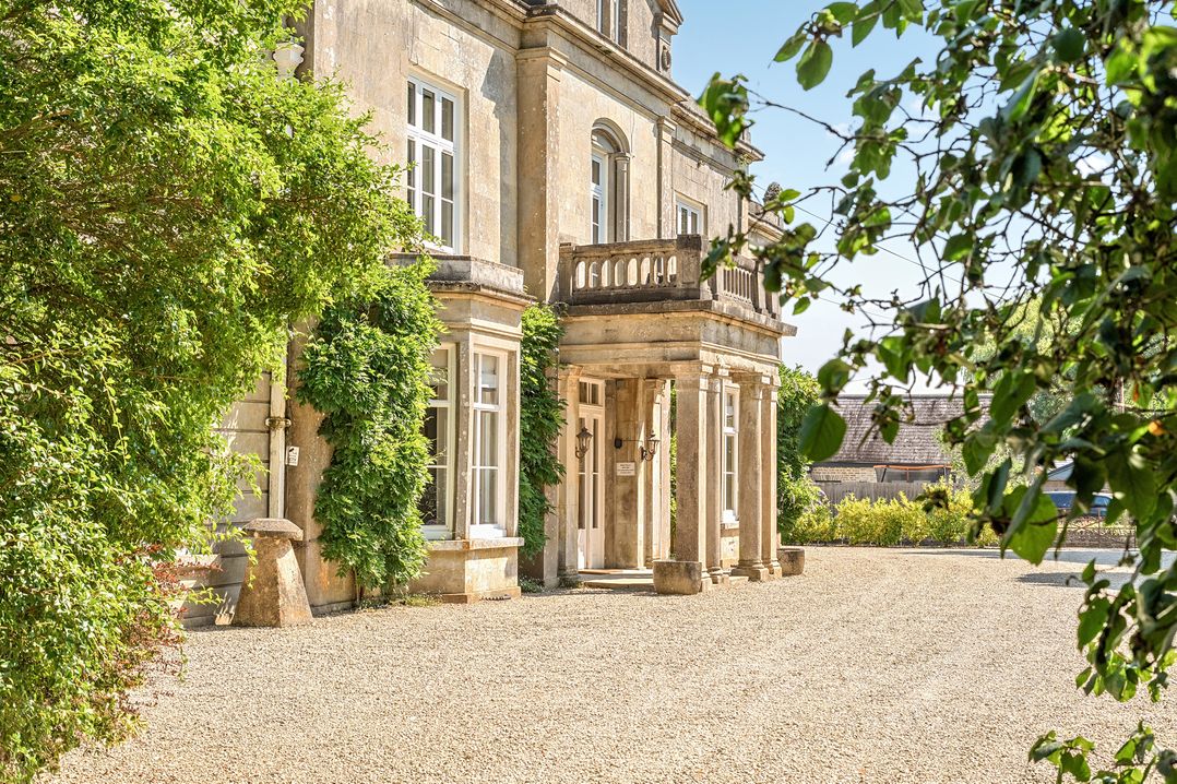 A building with columns and windows at Milton Manor in Milton On Stour