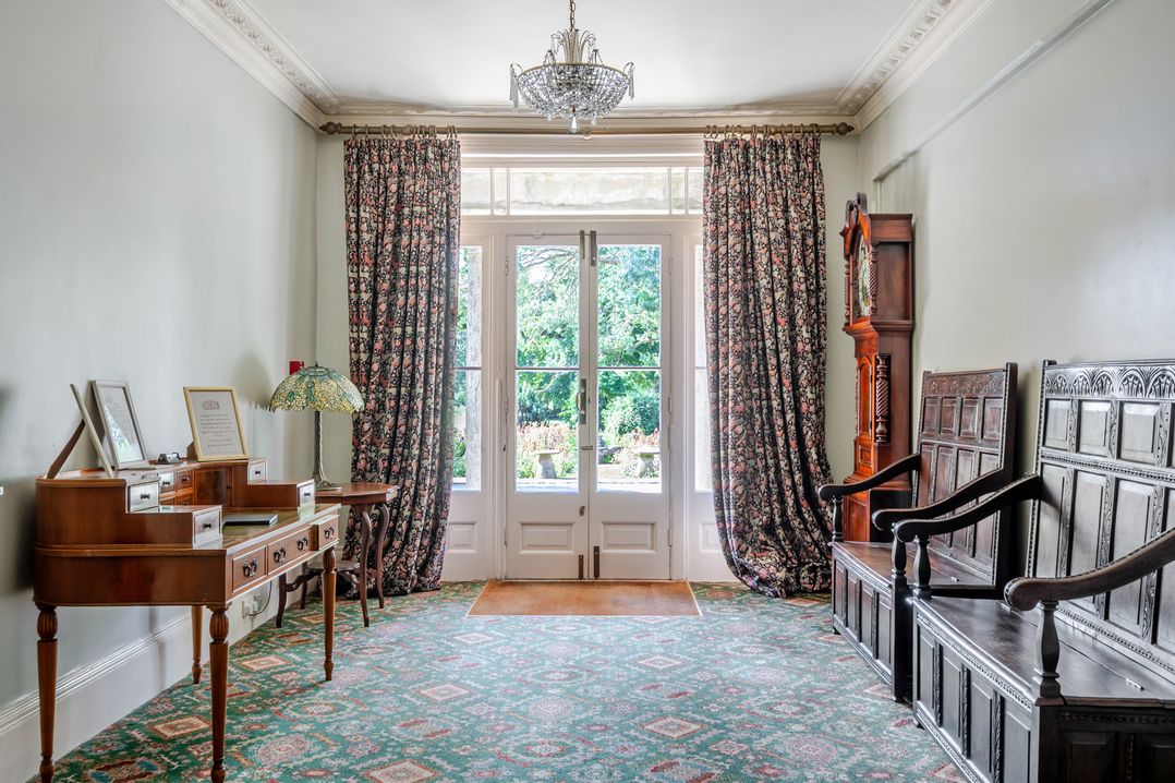 A hall with a table and decorative chairs at Milton Manor in Milton On Stour