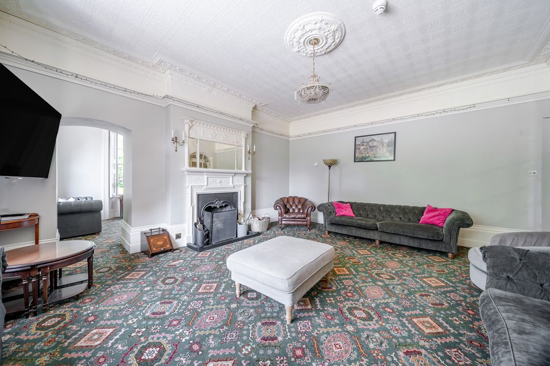 A living room with sofas, a fireplace and a coffee table at Milton Manor in Milton On Stour