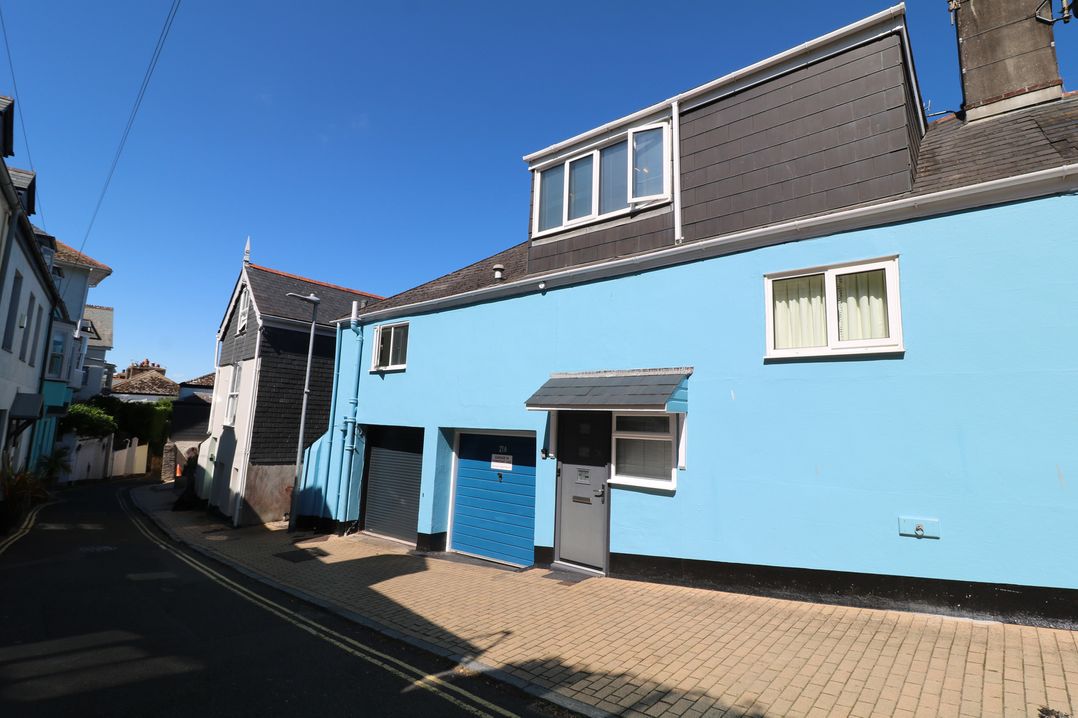 A building with a blue exterior and garages at 21 Above Town Dartmouth
