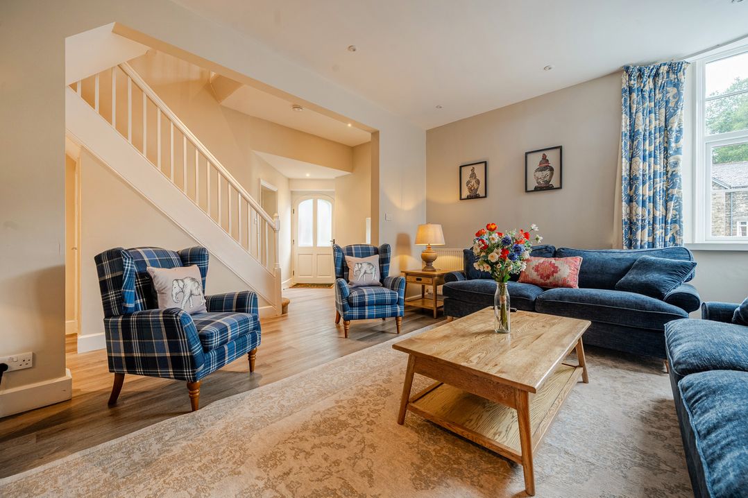 A living room with a sofa and armchairs at Home Farmhouse at the Graythwaite Estate near Hawkshead