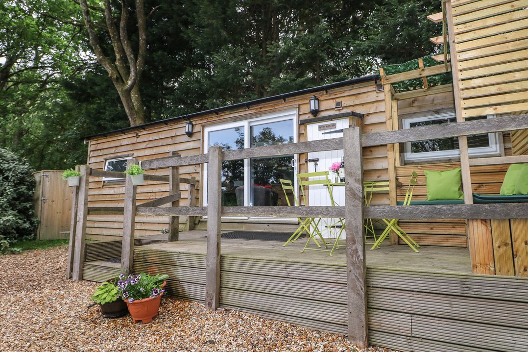An outdoor area with seating and planters at Harvest Lodge in Wineham near Bolney