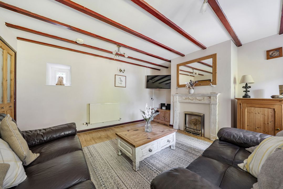 A living room with a sofa and coffee table at Tyn Y Ffynnon in Betws-Y-Coed