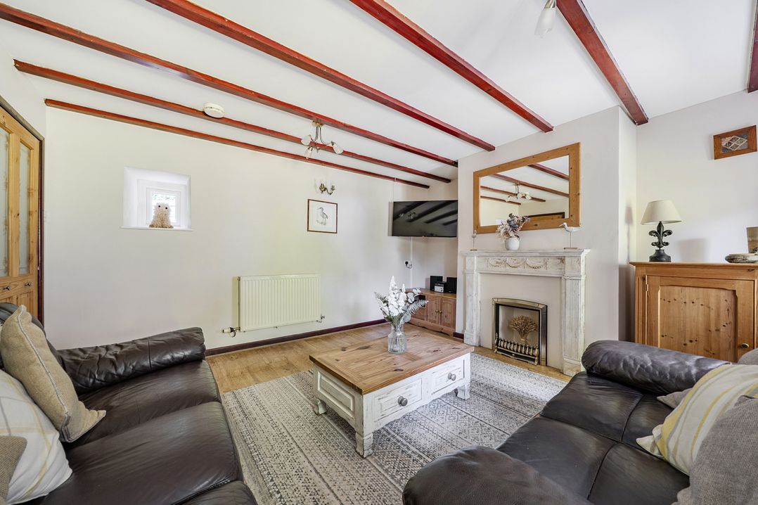 A living room with a sofa and coffee table at Tyn Y Ffynnon in Betws-Y-Coed