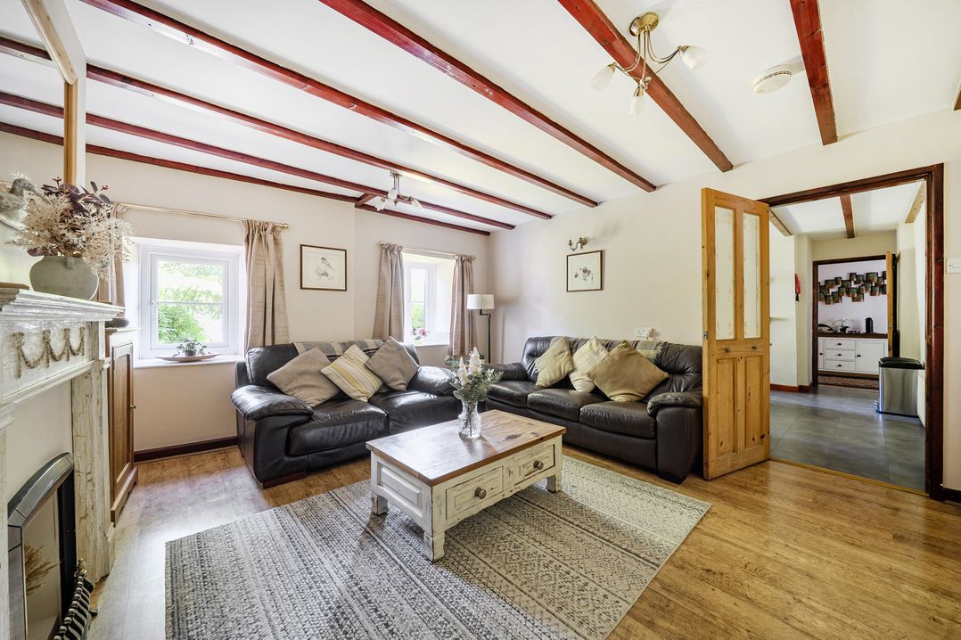 A living room with a sofa and coffee table at Tyn Y Ffynnon in Betws-Y-Coed