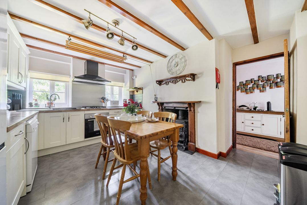 A kitchen with a dining table and chairs at Tyn Y Ffynnon in Betws-Y-Coed
