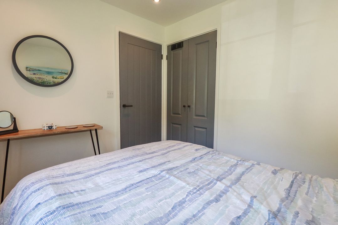 A bedroom with a bed and table at Lilyvale in Davidstow near Camelford