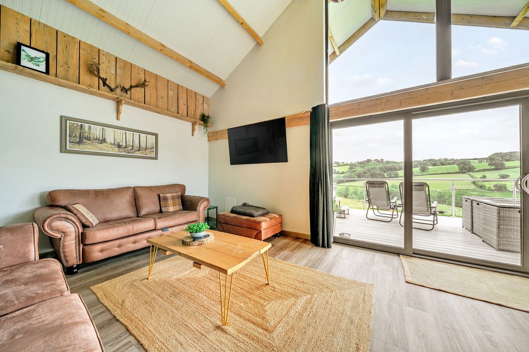 A living room with a sofa and coffee table at Bwncath in Garthmyl