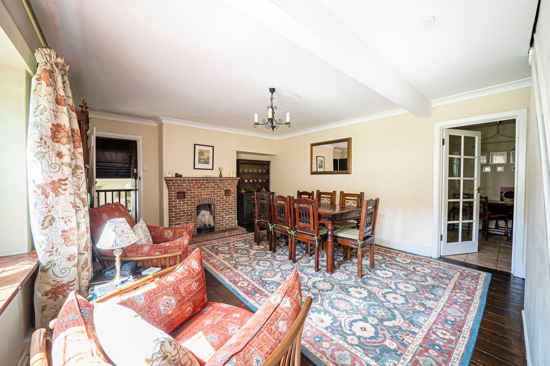 A living room with a dining table and fireplace at Primrose Spinney Highwood near Ringwood