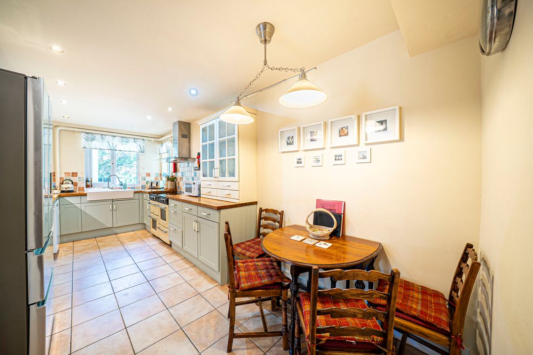 A kitchen with a dining table and chairs at Primrose Spinney in Highwood near Ringwood