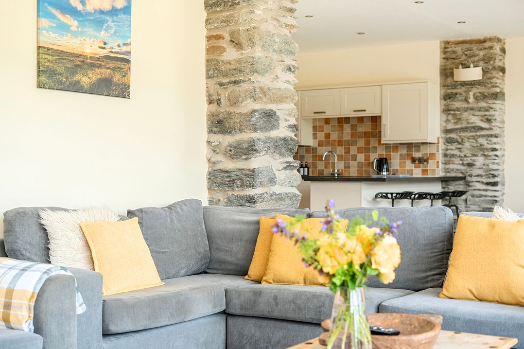 A living room with a sofa and coffee table at The Barn in Corwen