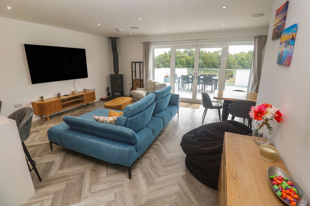 A living room with a sofa and television at Carnon Gwel, Devoran