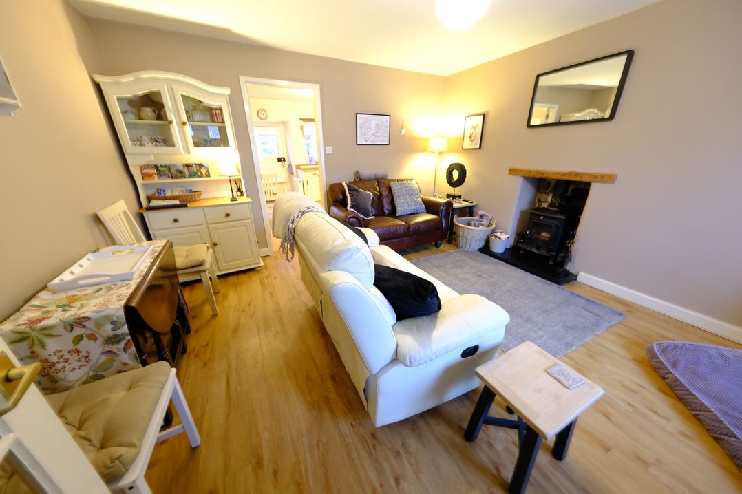 A living room with a sofa and coffee table at Rose Cottage in Hartington