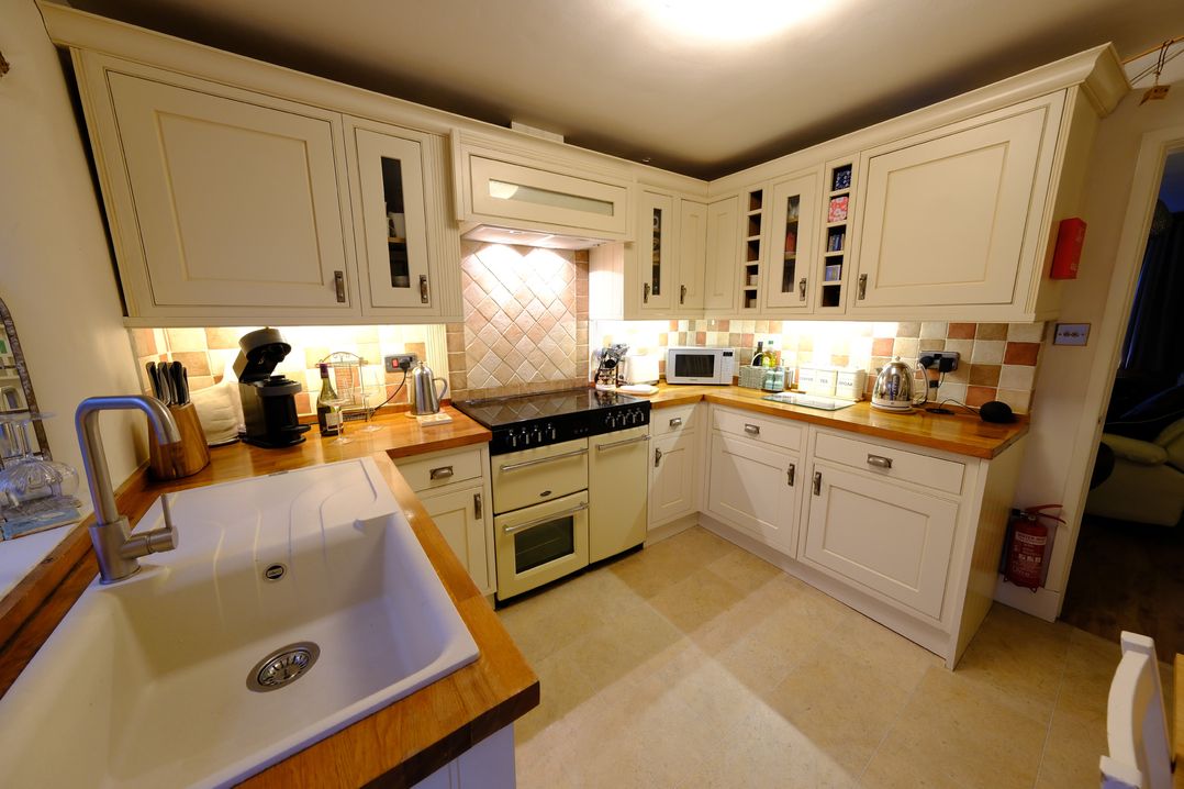 A kitchen with cabinets and appliances at Rose Cottage in Hartington