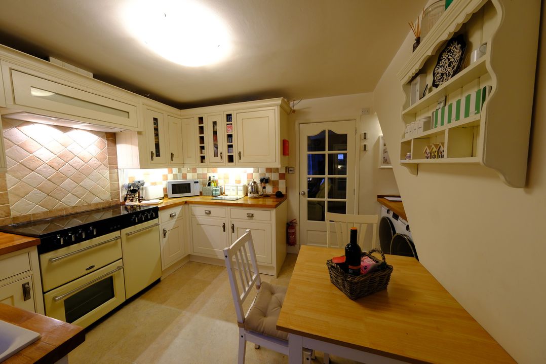 A kitchen with cabinets and appliances at Rose Cottage in Hartington