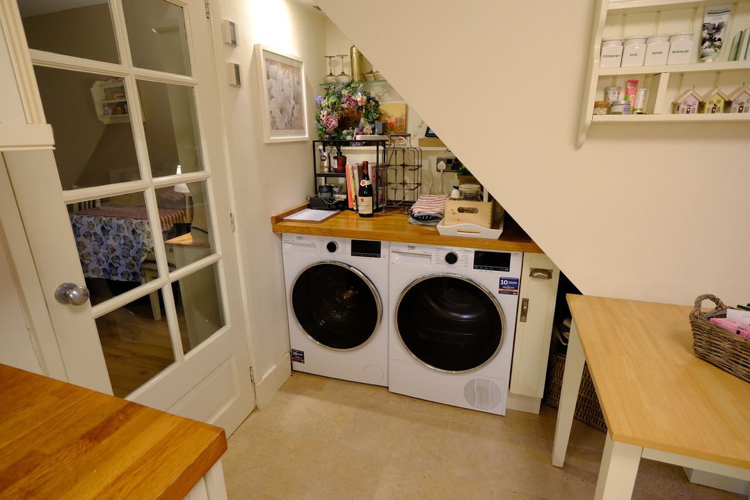 A laundry room with a washing machine and dryer at Rose Cottage in Hartington