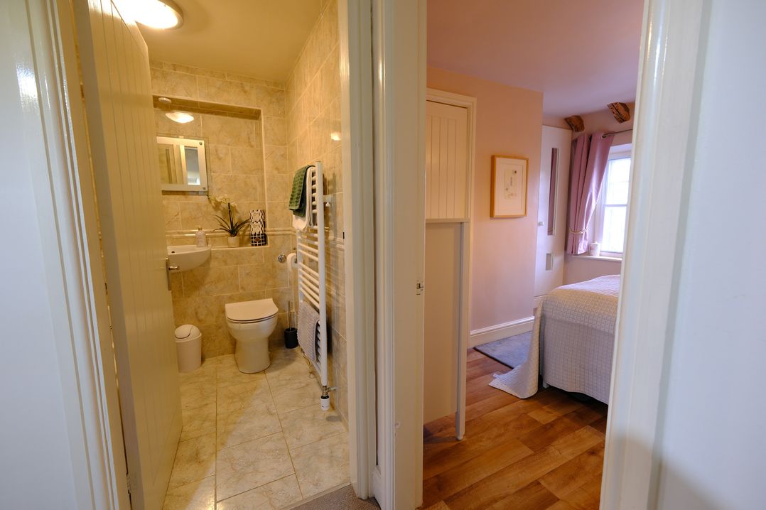 A bathroom with a toilet and sink at Rose Cottage in Hartington