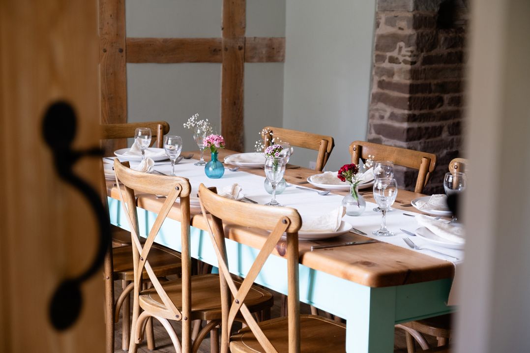 A dining room with a set table at Henhouse Farm in Bodenham