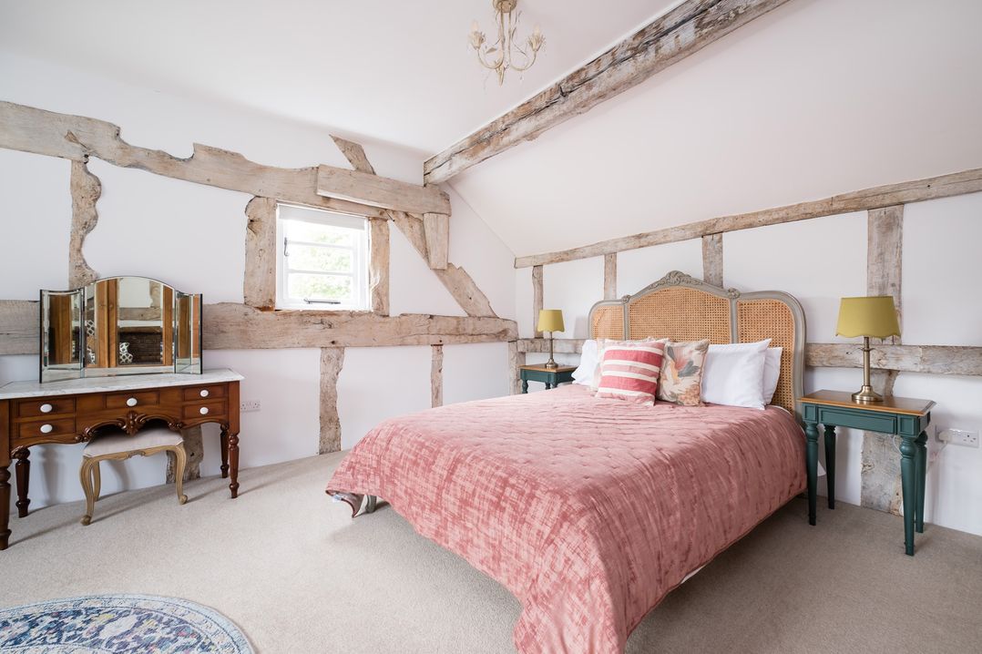 A bedroom with a bed and dressing table at Henhouse Farm in Bodenham