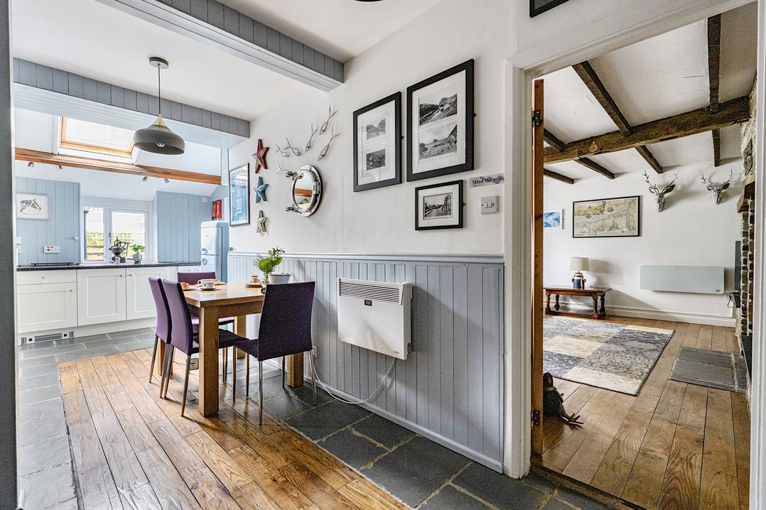 A dining room with a table and chairs at Mews Cottage in Tintagel