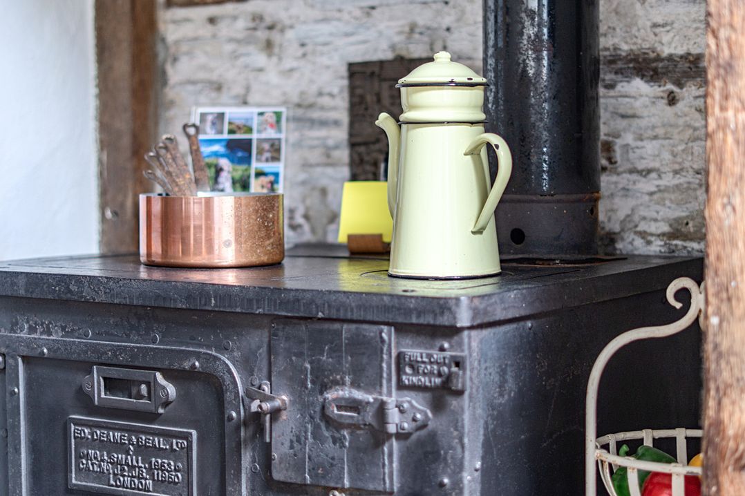 A kettle and utensils on a stove at Mews Cottage Tintagel