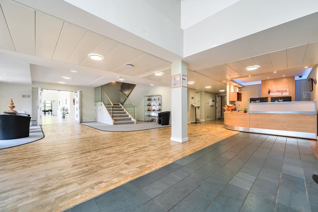 A lobby with a reception desk and staircase at Jubilee First-floor Double Bedroom Penrith