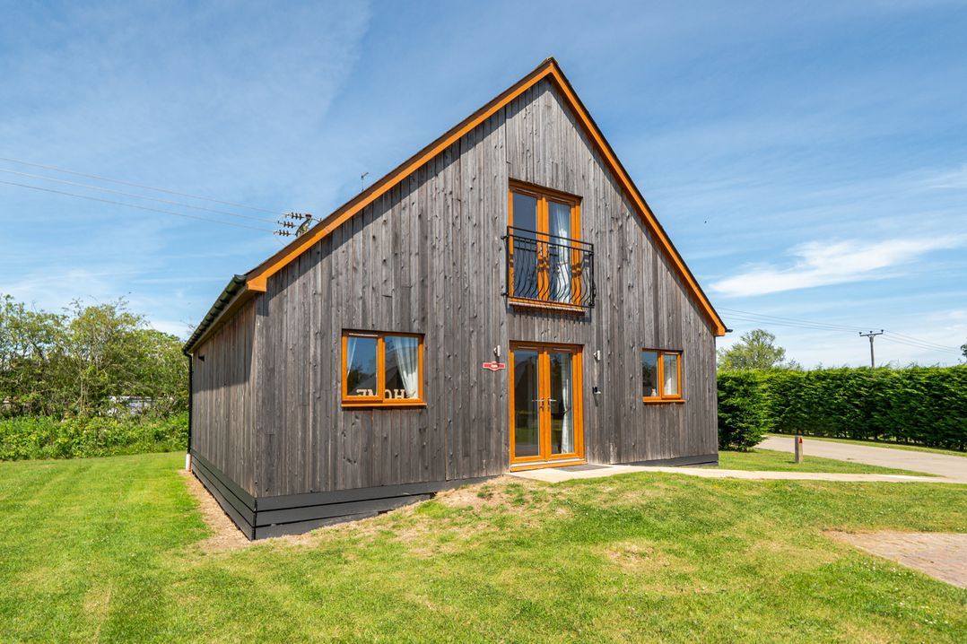 A house with windows and a balcony at Aspen Lodge Near Brigg