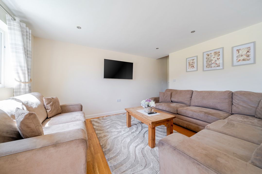 A living room with a television and a coffee table at Aspen Lodge Near Brigg