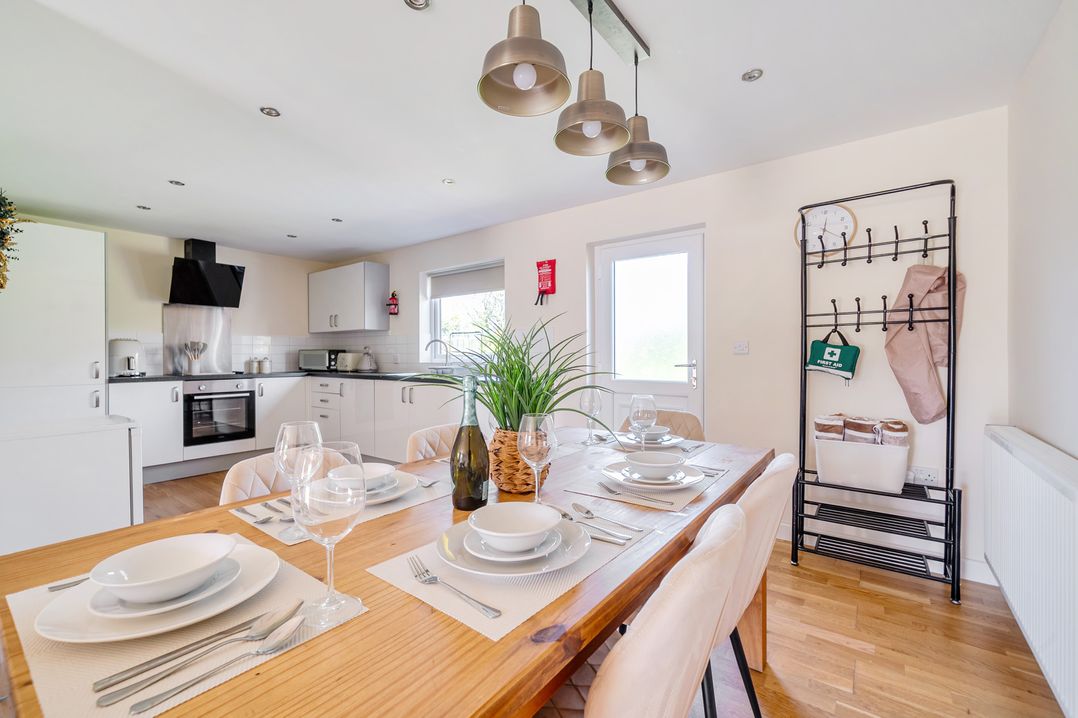 A dining room with a wooden table and chairs at Aspen Lodge near Brigg