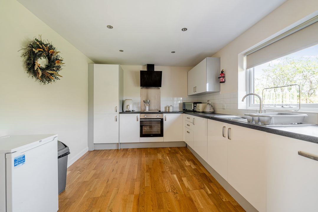 A kitchen with cabinets and appliances at Aspen Lodge Near Brigg