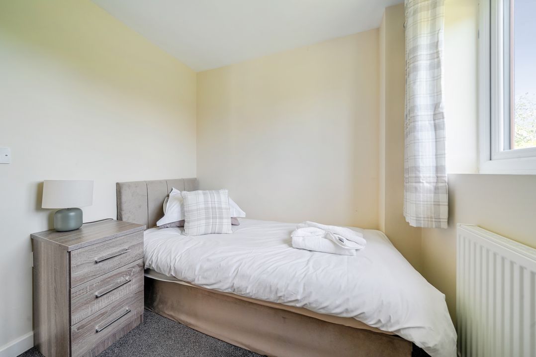 A bedroom with a bed and bedside table at Aspen Lodge Near Brigg