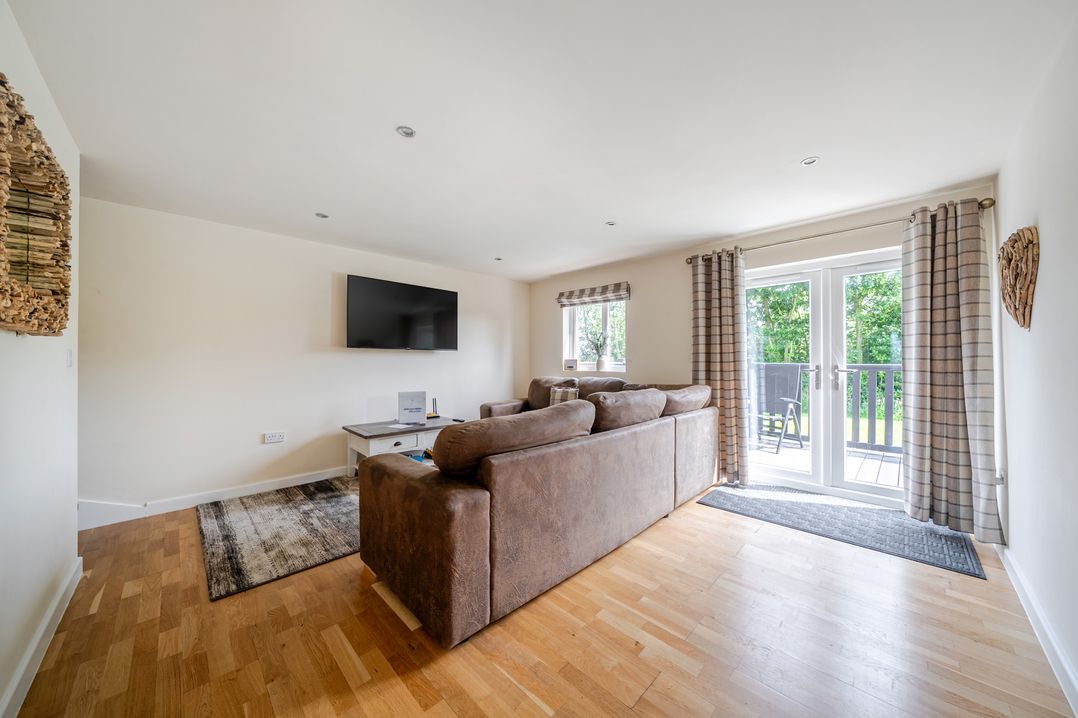 A living room with a sofa and television at Paddington Lodge near Brigg