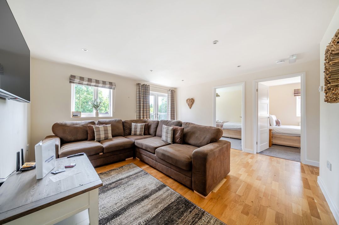 A living room with a sofa and television at Paddington Lodge near Brigg
