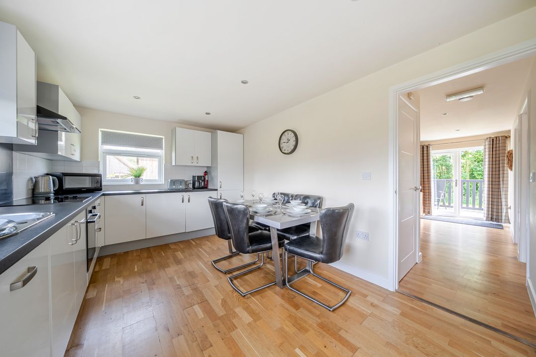 A kitchen with a dining table and chairs at Paddington Lodge near Brigg